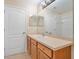 Bathroom with wood vanity and large mirror at 14248 Salvatierra Ln, Port Charlotte, FL 33981