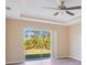 Bedroom with sliding glass doors leading to the backyard and wood-look flooring at 14248 Salvatierra Ln, Port Charlotte, FL 33981