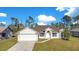 Single-story house with a white exterior, a two-car garage, and a neatly landscaped lawn at 14248 Salvatierra Ln, Port Charlotte, FL 33981