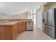 Kitchen with stainless steel appliances, wood cabinets, and a large island at 14248 Salvatierra Ln, Port Charlotte, FL 33981