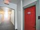 Apartment building hallway with a red apartment door at 210 3Rd W St # 8205, Bradenton, FL 34205