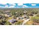 Aerial view of a residential neighborhood with houses and lush greenery at 2315 Snowflake Ln, North Port, FL 34286