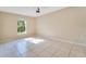 Well-lit bedroom featuring tile floors and a window at 2315 Snowflake Ln, North Port, FL 34286