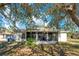 Rear view of house with screened porch and landscaping at 2315 Snowflake Ln, North Port, FL 34286