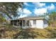 House exterior showcasing a screened porch and lawn at 2315 Snowflake Ln, North Port, FL 34286