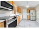 Kitchen with stainless steel appliances and wood cabinets at 2315 Snowflake Ln, North Port, FL 34286