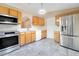 Kitchen with stainless steel appliances and wood cabinets at 2315 Snowflake Ln, North Port, FL 34286