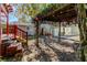 Landscaped backyard with pergola and wooden deck at 7108 N 10Th St, Tampa, FL 33604