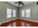 Well-lit bedroom featuring hardwood floors and two windows at 7108 N 10Th St, Tampa, FL 33604