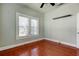 Simple bedroom with hardwood floors and a ceiling fan at 7108 N 10Th St, Tampa, FL 33604