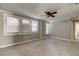 Spacious bedroom with ceiling fan, neutral walls, and carpeted floor at 7108 N 10Th St, Tampa, FL 33604