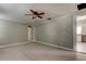 Bedroom with ceiling fan and access to kitchen area at 7108 N 10Th St, Tampa, FL 33604