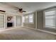 Primary bedroom with ceiling fan, neutral walls, and carpeted floor at 7108 N 10Th St, Tampa, FL 33604