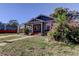 House exterior showcasing a walkway and blooming flowers at 7108 N 10Th St, Tampa, FL 33604