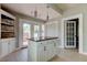 Kitchen island with granite countertop and white cabinets, offering extra prep space at 7108 N 10Th St, Tampa, FL 33604