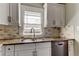 Modern kitchen featuring granite countertops, stainless steel appliances, and white cabinets at 7108 N 10Th St, Tampa, FL 33604