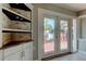 View from kitchen to backyard deck through French doors at 7108 N 10Th St, Tampa, FL 33604