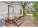 Home's exterior with wooden steps and deck at 7495 Mitchell Rd, Brooksville, FL 34601