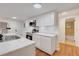 Modern kitchen with white cabinets, stainless steel appliances, and a view of the bathroom at 7495 Mitchell Rd, Brooksville, FL 34601