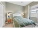 Light and airy bedroom with green bedding and a window at 8796 Little Bluestem Dr, Land O Lakes, FL 34637