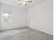 Well-lit bedroom featuring grey carpet and a ceiling fan at 8796 Little Bluestem Dr, Land O Lakes, FL 34637