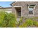 Front entry with stone facade and landscaping at 8796 Little Bluestem Dr, Land O Lakes, FL 34637