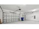 Attached garage with an overhead door and ample space for storage at 8796 Little Bluestem Dr, Land O Lakes, FL 34637