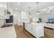 Open concept kitchen island with white cabinets and stainless steel appliances at 8796 Little Bluestem Dr, Land O Lakes, FL 34637