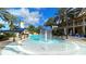 Community pool with a lighthouse water feature and surrounding palms at 1003 Signet Dr, Apollo Beach, FL 33572