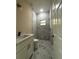 A bathroom featuring a marble tiled shower and flooring, complete with sleek modern fixtures at 1504 Kohlenberg Ave, North Port, FL 34288