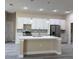 Kitchen featuring white cabinets, an island, stainless steel appliances, and modern pendant lights at 1504 Kohlenberg Ave, North Port, FL 34288