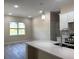 Kitchen featuring an island, undermount sink, quartz countertops, and pendant lighting at 1504 Kohlenberg Ave, North Port, FL 34288