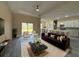 Staged living room with a view to the kitchen, dining area, and glass doors to the backyard at 1504 Kohlenberg Ave, North Port, FL 34288