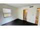 Bright bedroom with dark flooring and access to a small bathroom at 7120 Waterside Dr # 34, Tampa, FL 33617