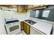 Kitchen with white appliances and wood cabinets at 7120 Waterside Dr # 34, Tampa, FL 33617