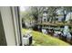 View of a pond with lush landscaping and AC unit at 7120 Waterside Dr # 34, Tampa, FL 33617