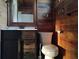 Clean bathroom featuring a toilet, vanity, and wood-paneled walls at 718 New York St, Clearwater, FL 33756