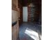 Entryway featuring dark wood walls and new dark flooring leading to an interior door and window at 718 New York St, Clearwater, FL 33756