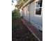 Exterior view showing the side of the home, a brick walkway, and surrounding yard at 718 New York St, Clearwater, FL 33756