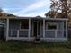 Front porch featuring white railings, a covered entryway, and blue painted exterior at 718 New York St, Clearwater, FL 33756