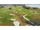 An aerial view of the golf course with trees and sand traps at 718 New York St, Clearwater, FL 33756