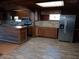 Rustic kitchen with wood cabinets, island, and stone backsplash at 718 New York St, Clearwater, FL 33756