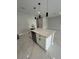 Modern kitchen island with white cabinets and quartz countertop at 7340 Bass St, Englewood, FL 34224