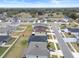 Aerial view of a new residential development with numerous homes and landscaping at 9474 Sanders Park Pl, Seffner, FL 33584