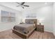 Spacious bedroom with a wooden platform bed and ensuite bathroom access at 9474 Sanders Park Pl, Seffner, FL 33584