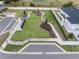 An aerial view of a neighborhood park with walking paths and benches at 9474 Sanders Park Pl, Seffner, FL 33584