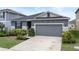 Gray exterior and neatly landscaped front yard add to the appeal of this one-story house at 9474 Sanders Park Pl, Seffner, FL 33584