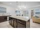 Island kitchen with granite countertops and dark wood cabinets at 9474 Sanders Park Pl, Seffner, FL 33584