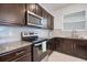 Stainless steel appliances and granite countertops feature in this updated kitchen at 9474 Sanders Park Pl, Seffner, FL 33584