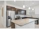 Modern kitchen with dark cabinets, granite countertops, and stainless steel appliances at 9474 Sanders Park Pl, Seffner, FL 33584